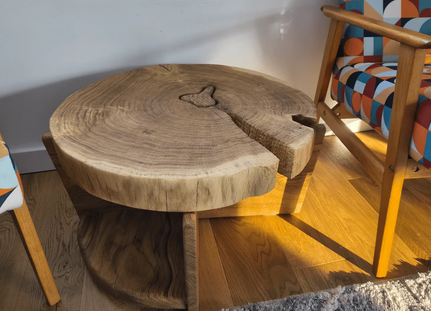 Black Hole side table — oak slab with cut-out centre and undulating shelves