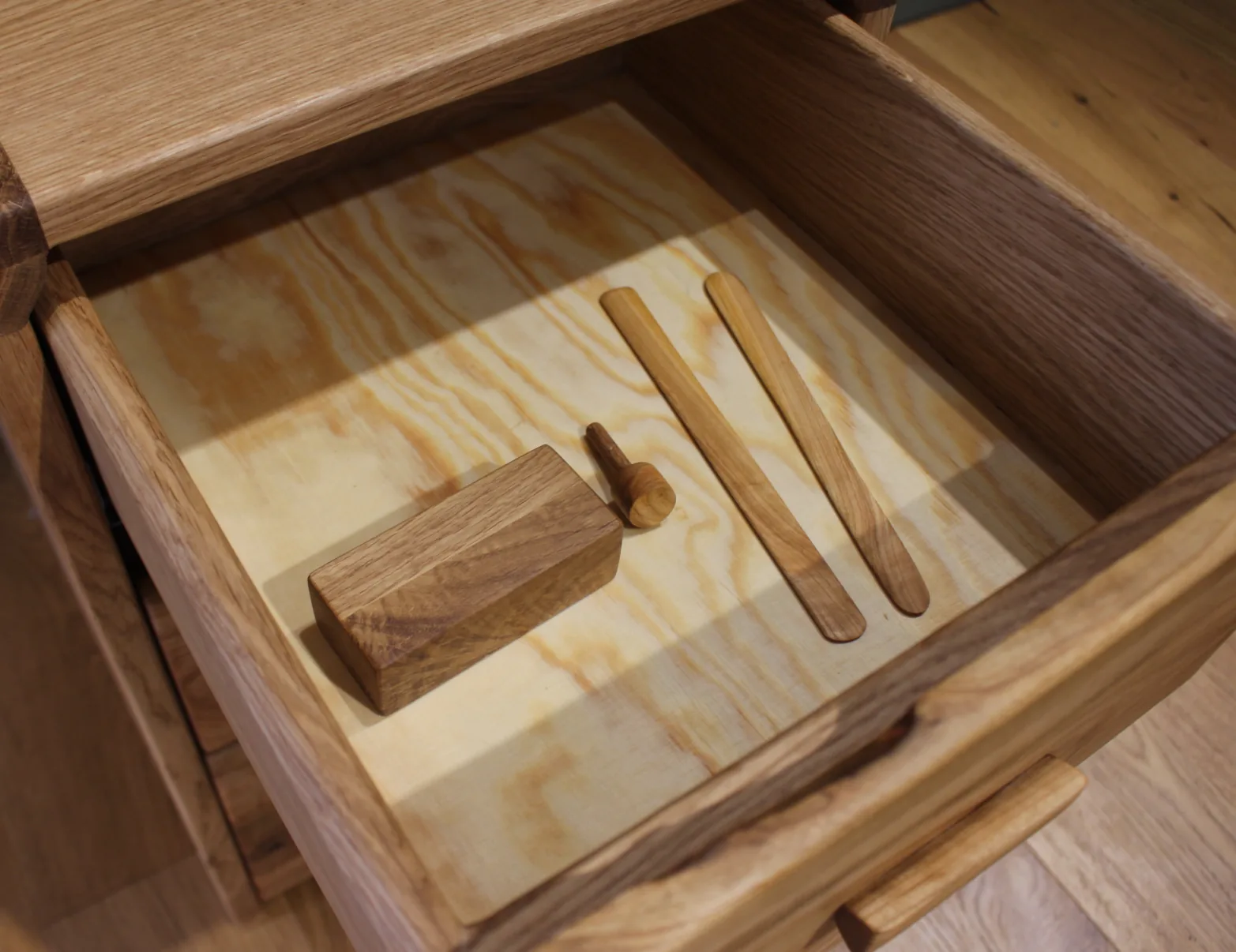 Andvari — spare peg, cherry bookmarks and a paperweight on the drawer bottom